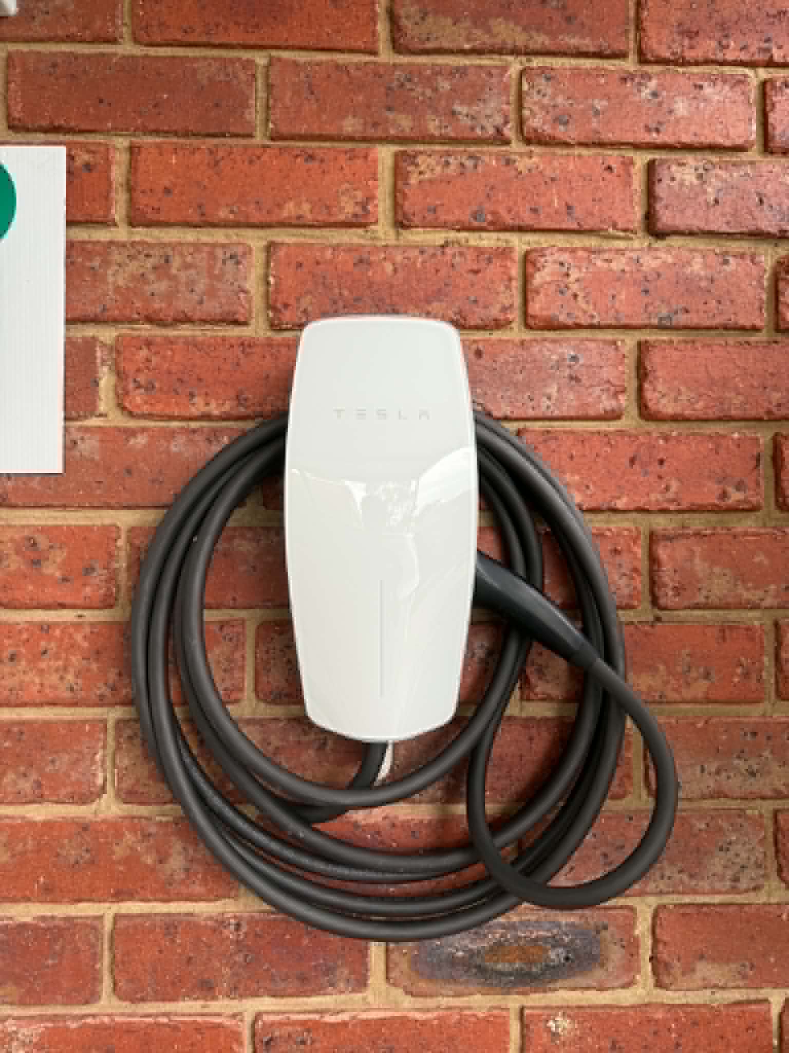 Tesla wall charger installed in a garage by Ampix Electrical